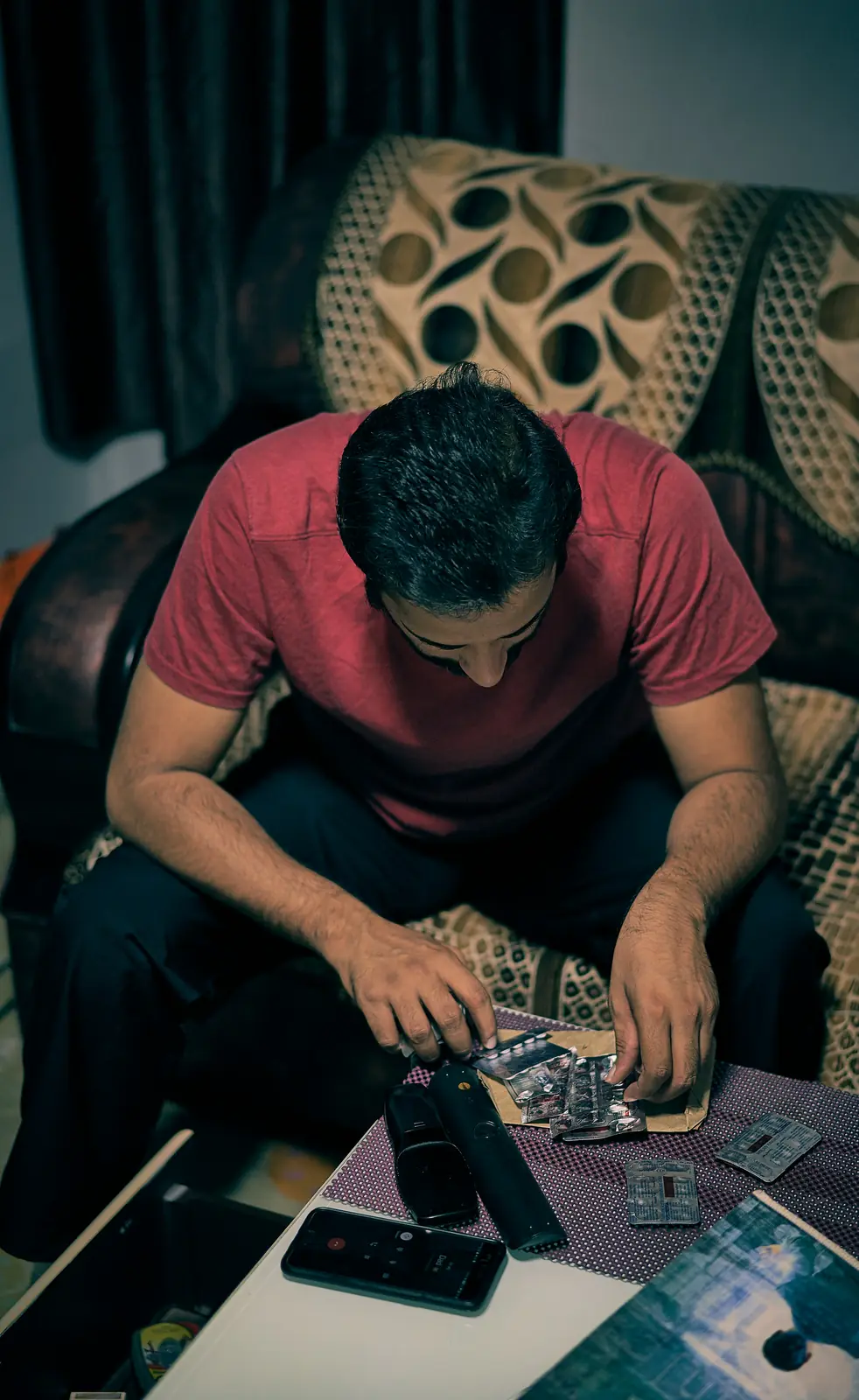A man concentrating on a hands-on craft project