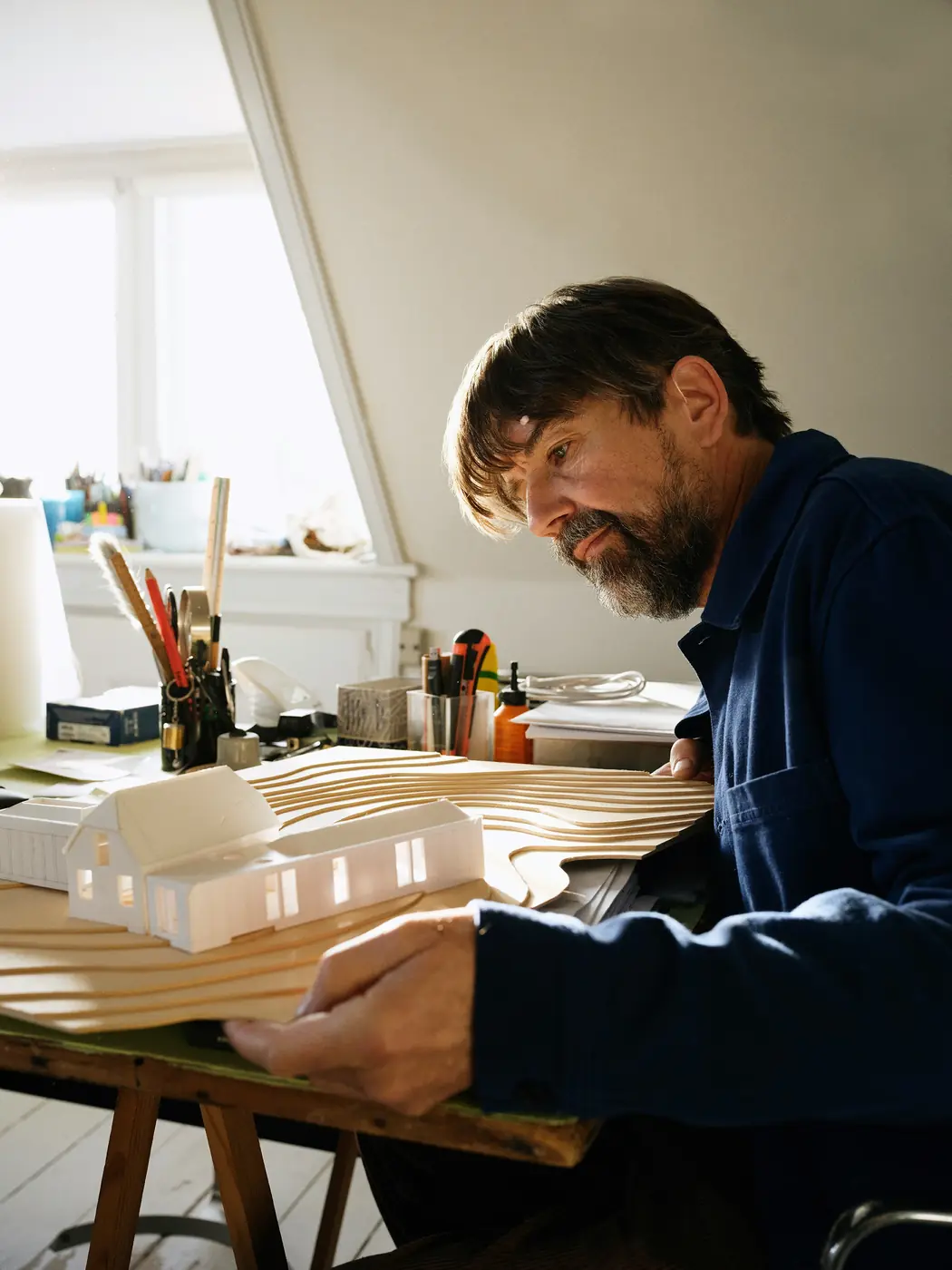 A man working independently on an architectural model