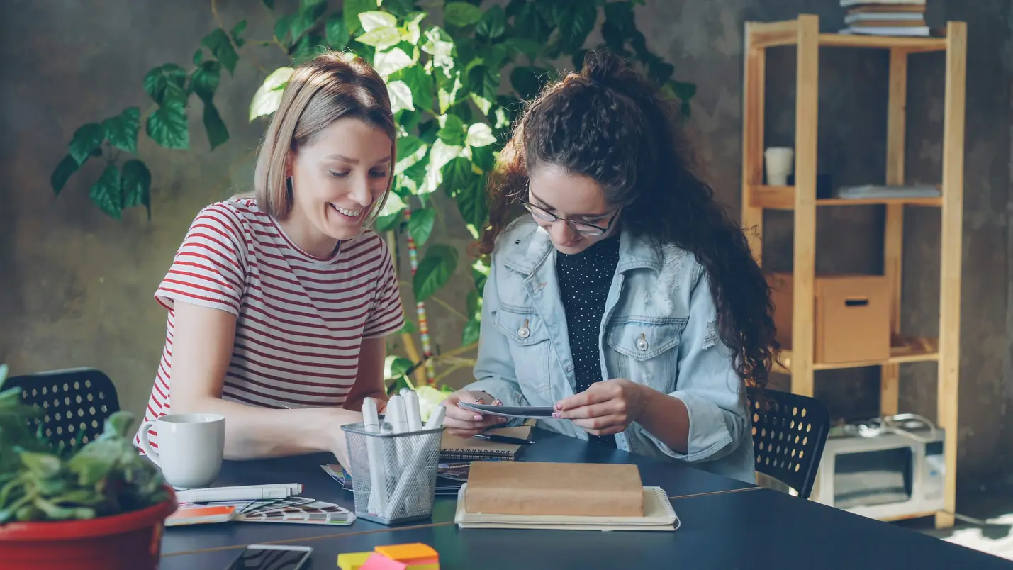 Two women working creatively together